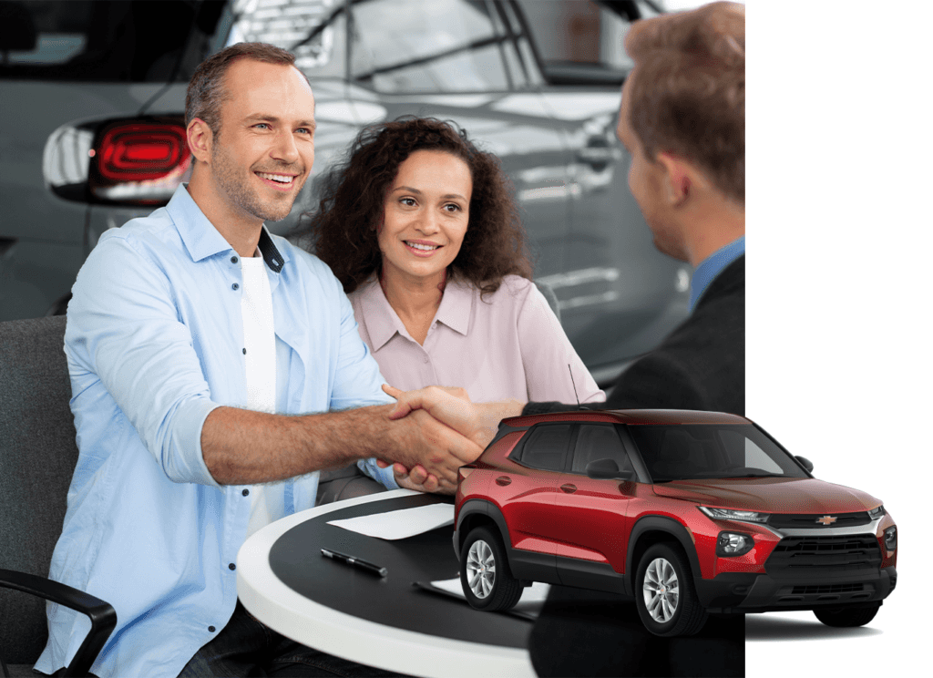 Best Time To Buy At Performance Chevrolet in Elizabeth City, NC | Red 2022 Chevrolet TrailBlazer with a background photo of a couple smiling and shaking hands with the sales person on car deal 