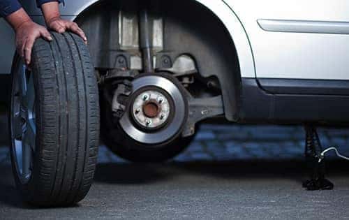 Mechanic rolling a wheel