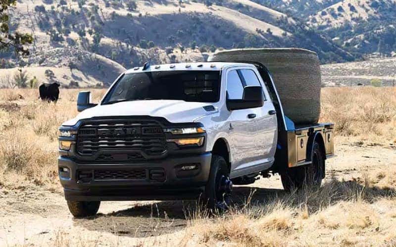 Ram Chassis Cab truck with an installed flatbed carrying hay