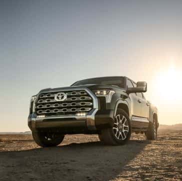 A Toyota Tundra parked with the sun setting in the background