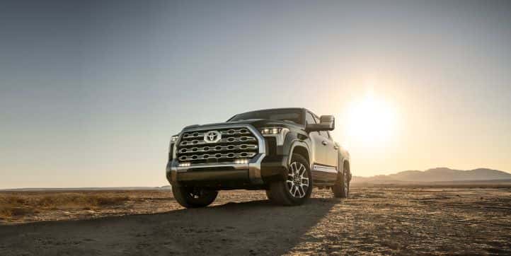 A Toyota Tundra parked with the sun setting in the background