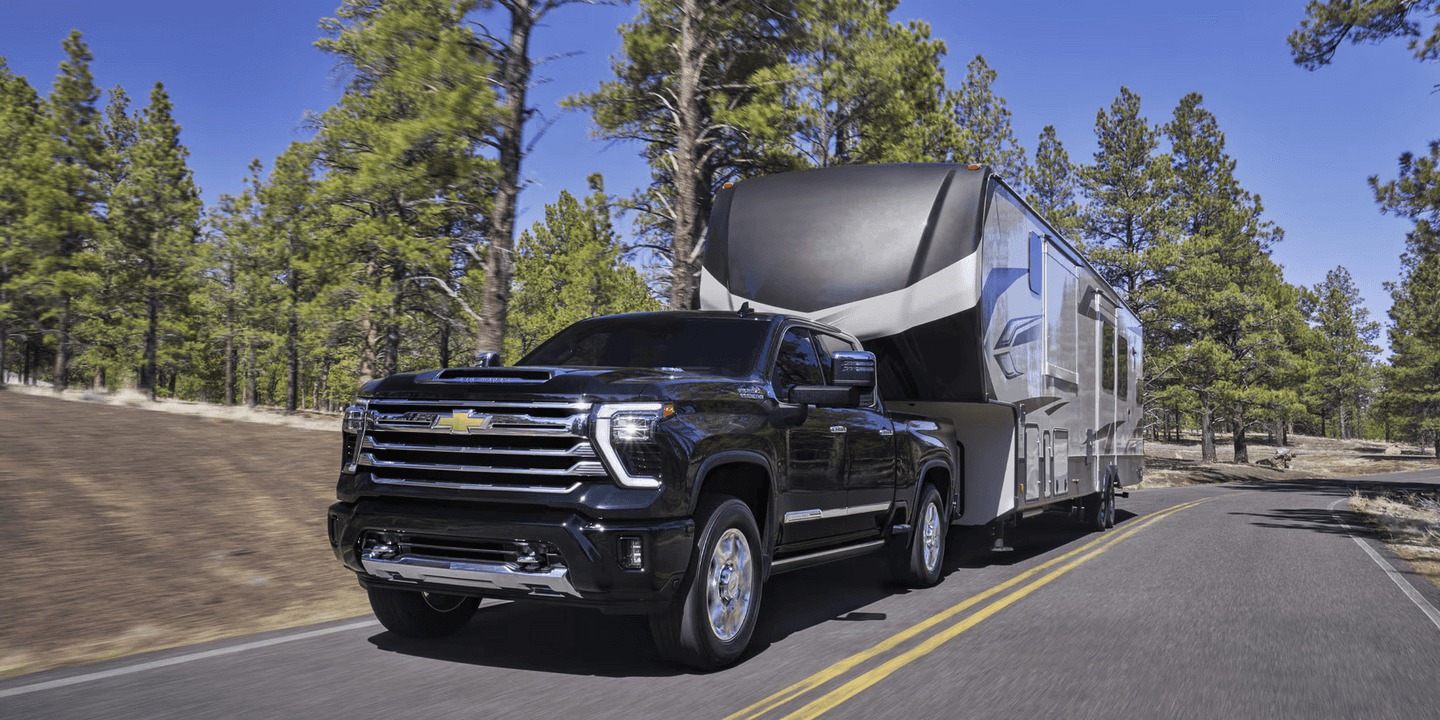 Black 2026 Chevy Silverado HD towing a RV