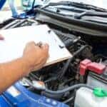 Service technician checking off inspection checklist items