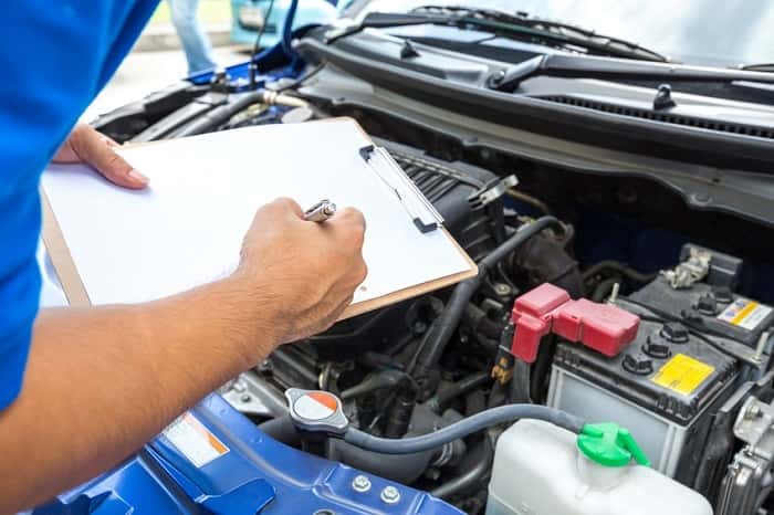 Service technician checking off inspection checklist items