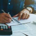 Person working on financing paperwork