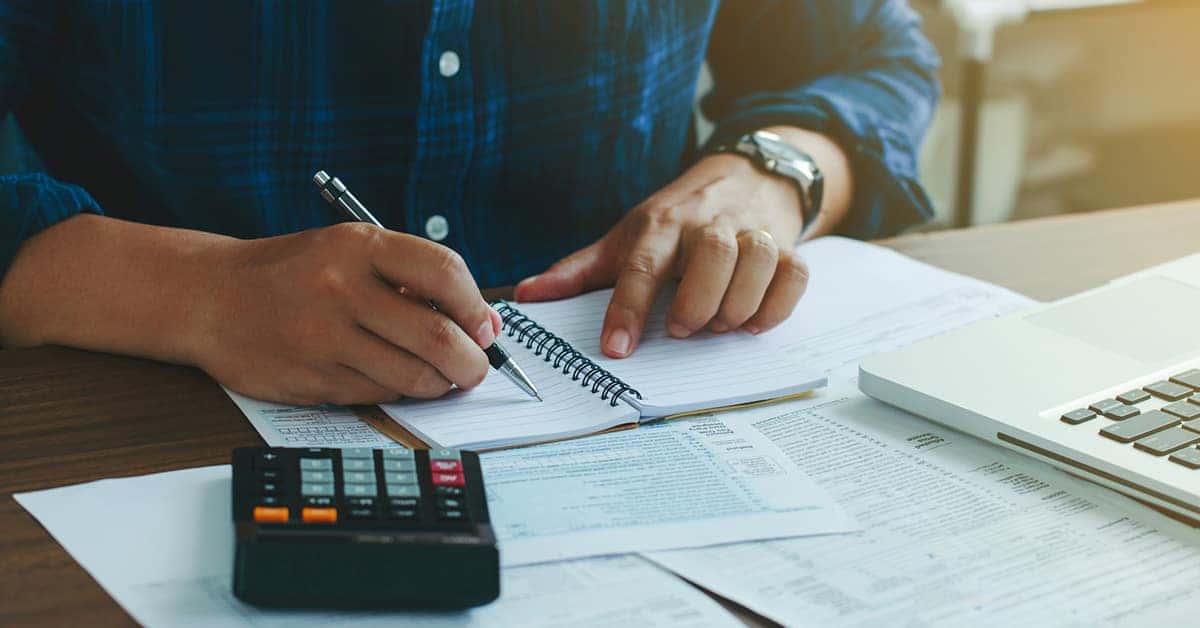 Person working on financing paperwork