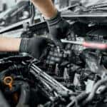 Service technician changing spark plugs