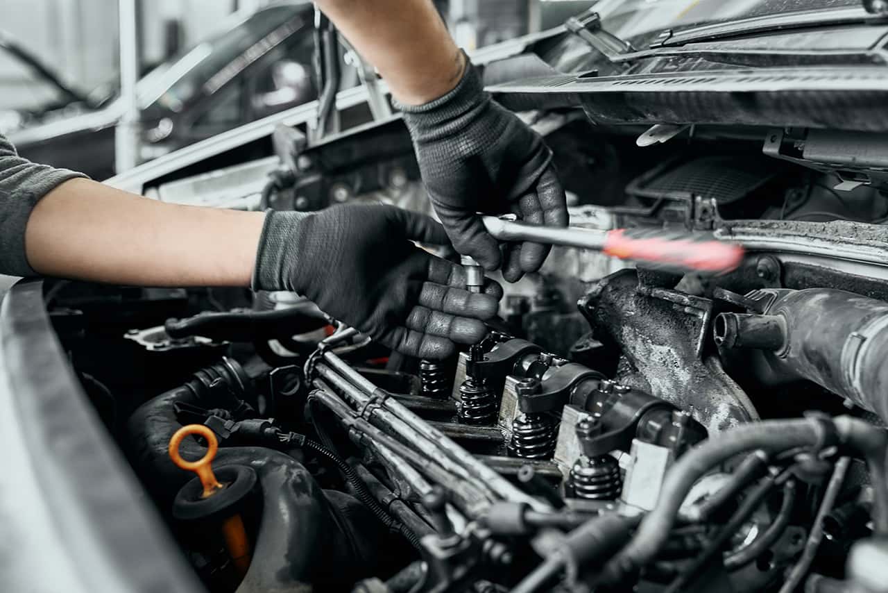 Service technician changing spark plugs