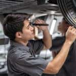 Chevrolet service technician inspecting tread depth
