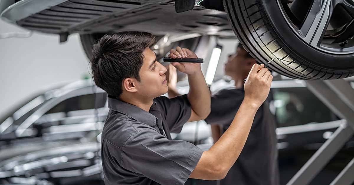 Chevrolet service technician inspecting tread depth