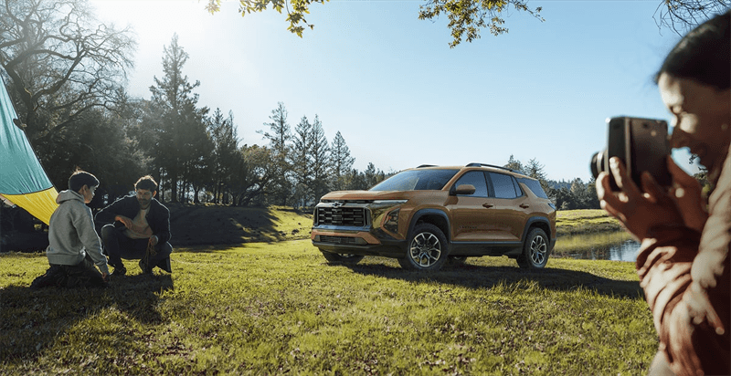2027 Chevrolet Equinox with a family outside